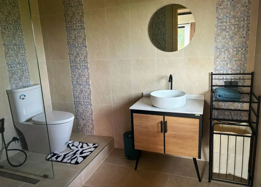 Bathroom with vessel sink and round mirror