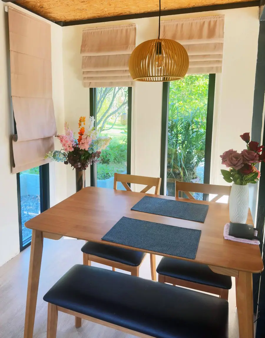 Wooden dining table with pendant lamp
