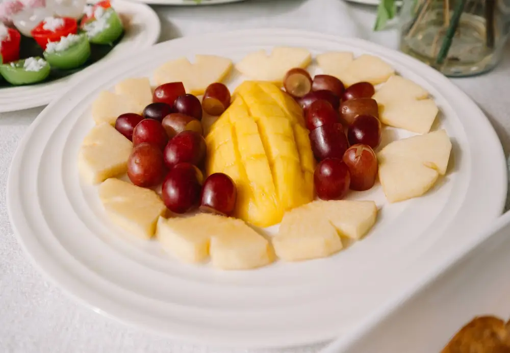 Plate of mango, pineapple and grapes