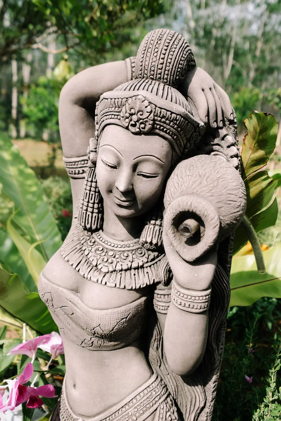 Stone statue among the flowers